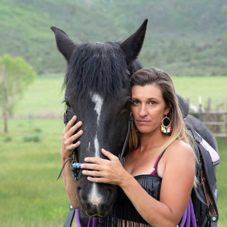 woman posing with horse