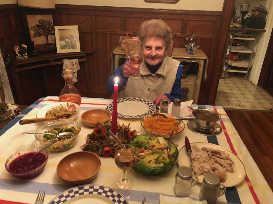 grandmother at the head of dinner table 