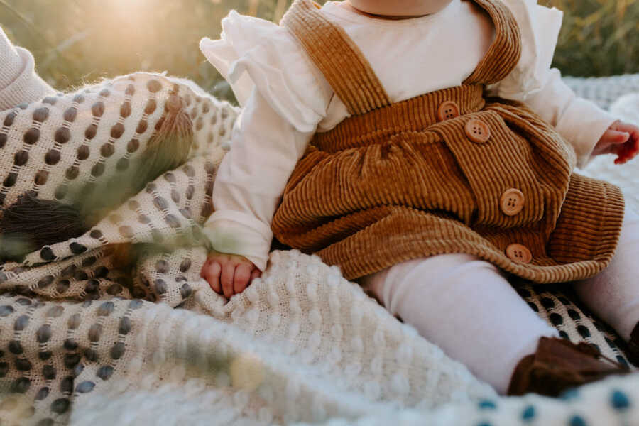 little girl sitting down 