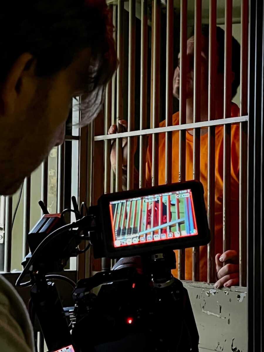 man being recorded in jail cell