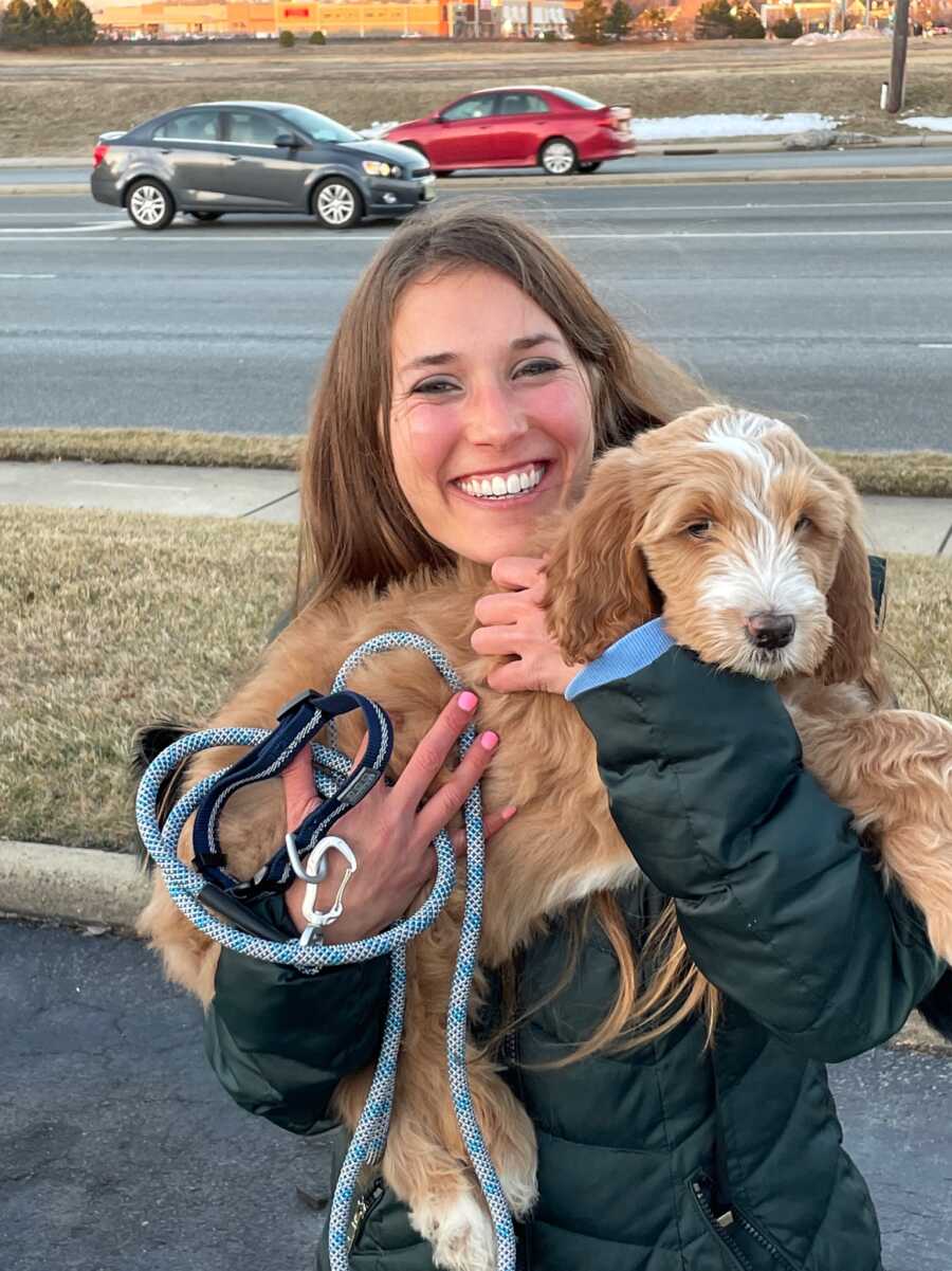 woman holding her new puppy
