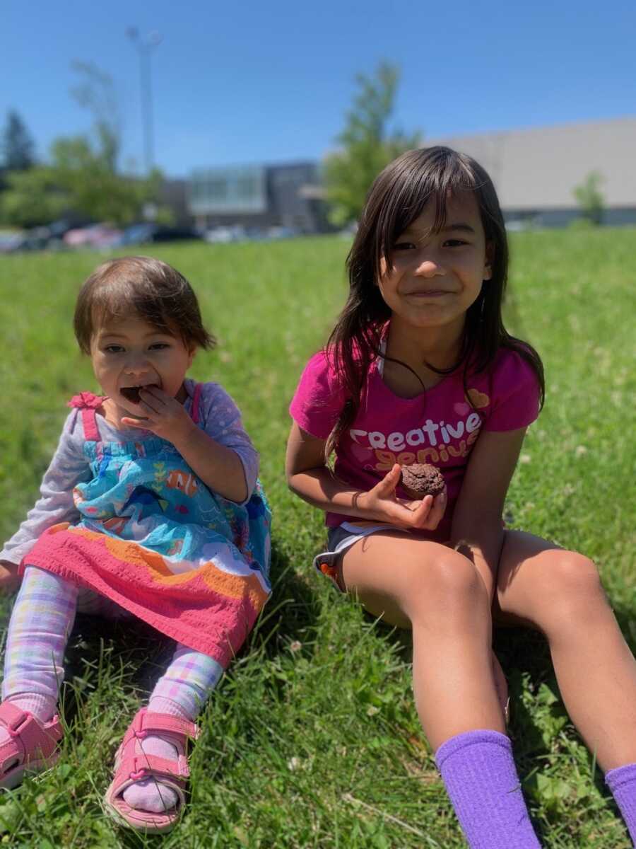 little girls with muffins in hands