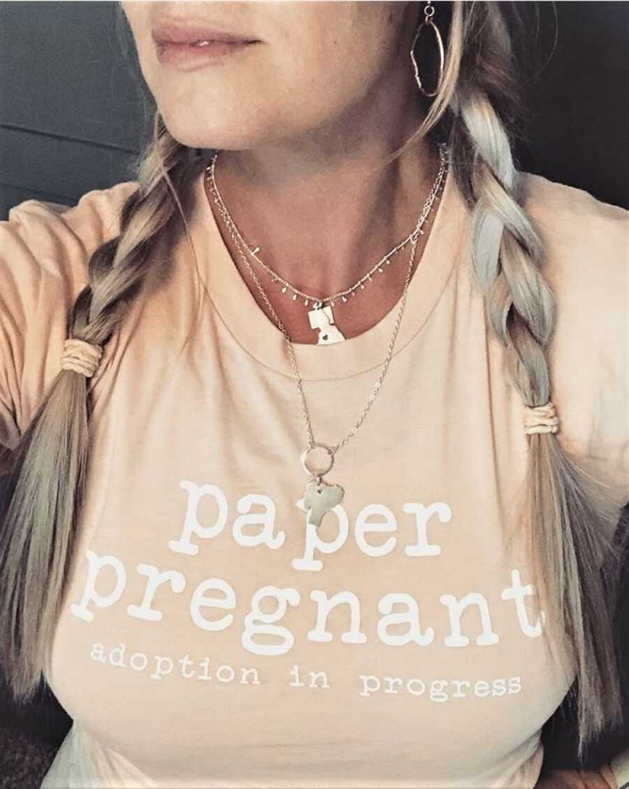 woman showing she is expecting a child through adoption