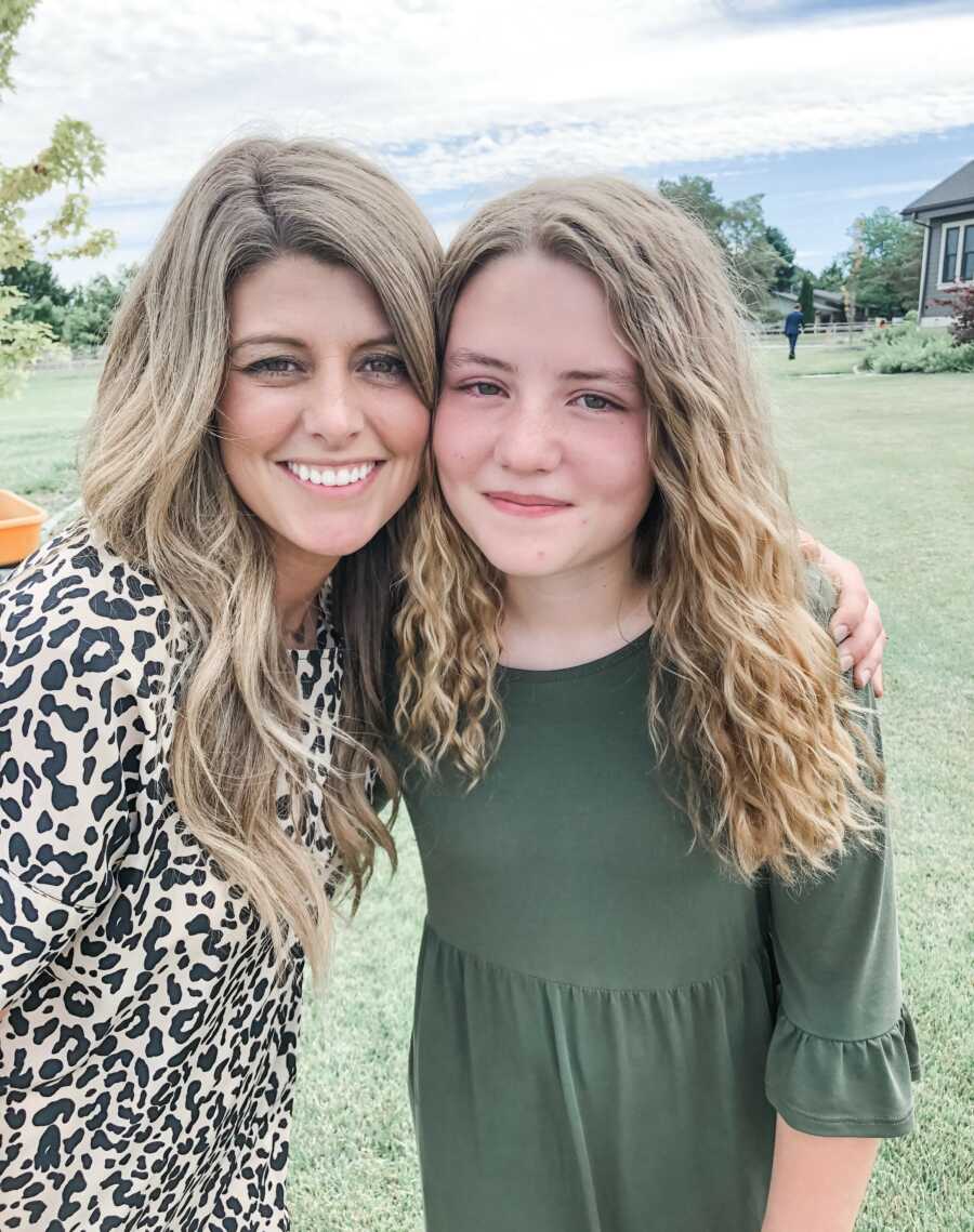 mom and daughter posing together