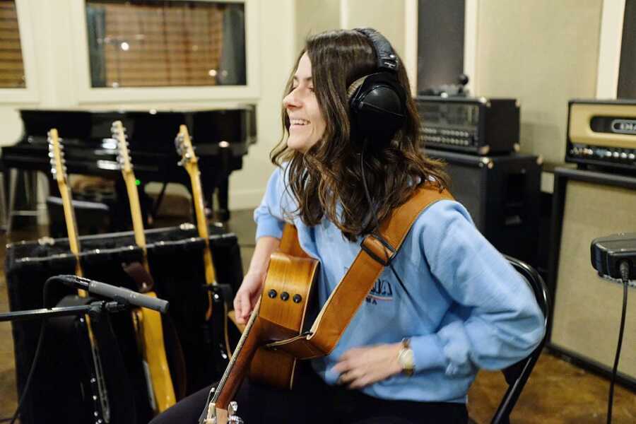 alex with guitar in studio