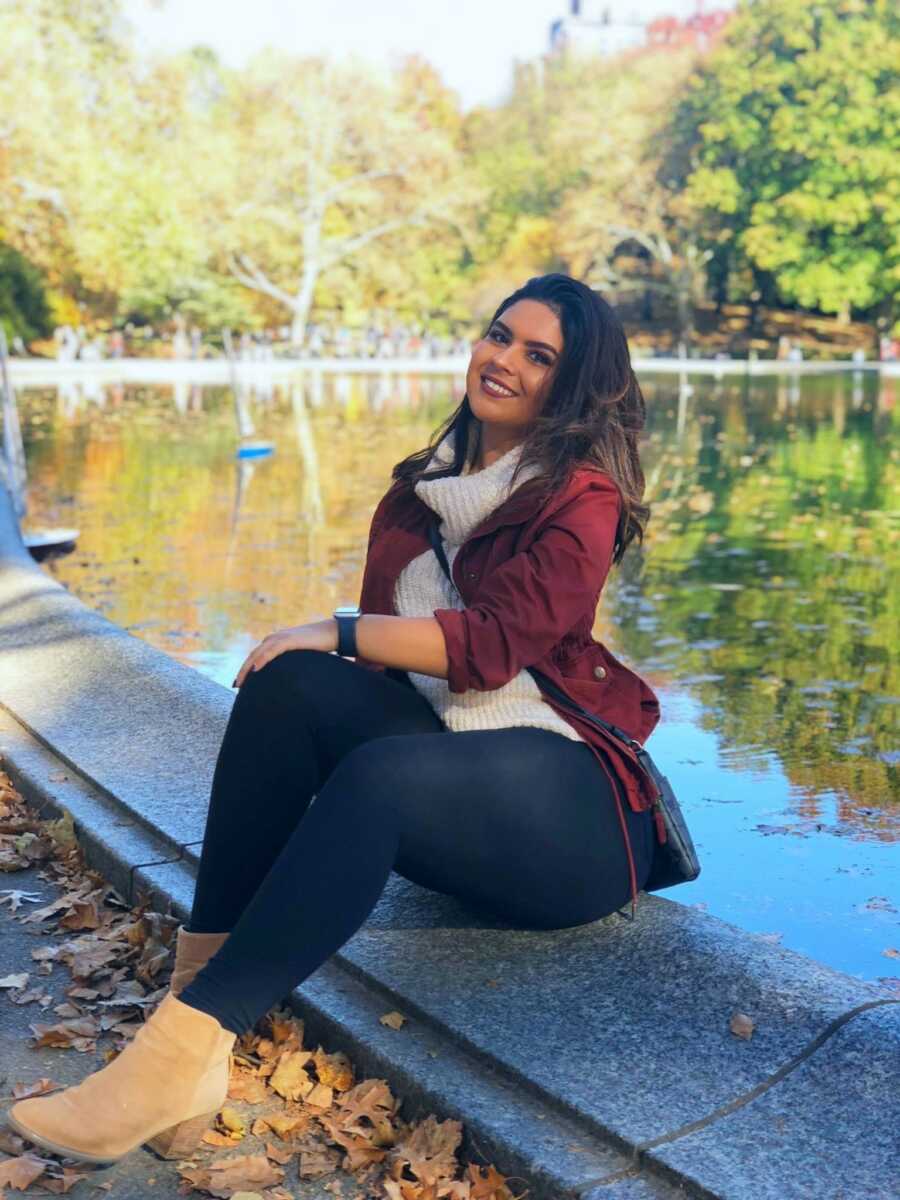 woman smiling by a pond