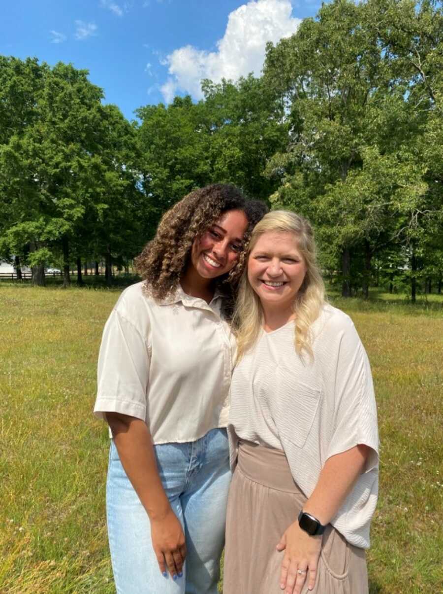 Young adult woman takes picture with foster mom who never gave up on her.