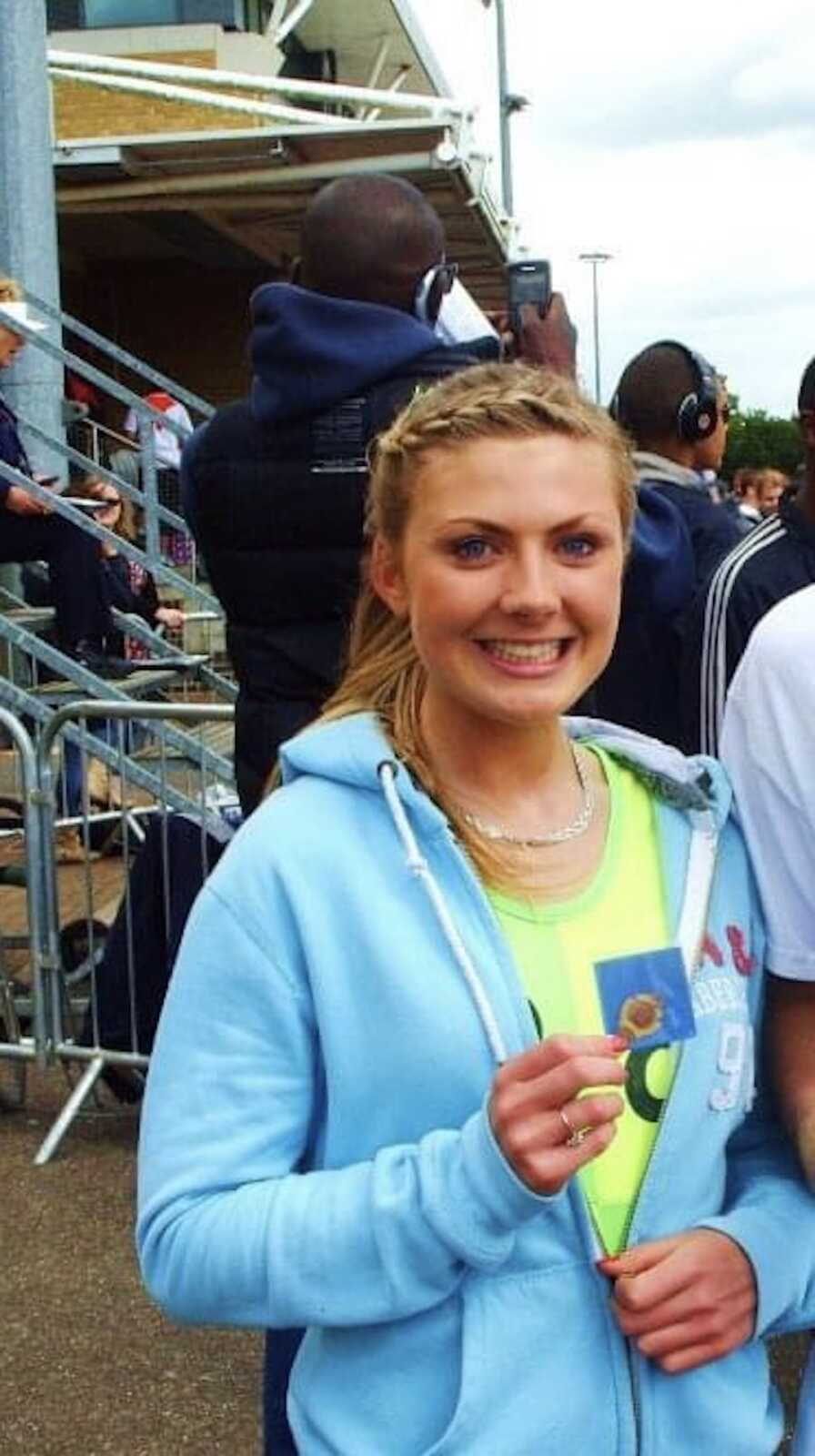 woman with medal in hands