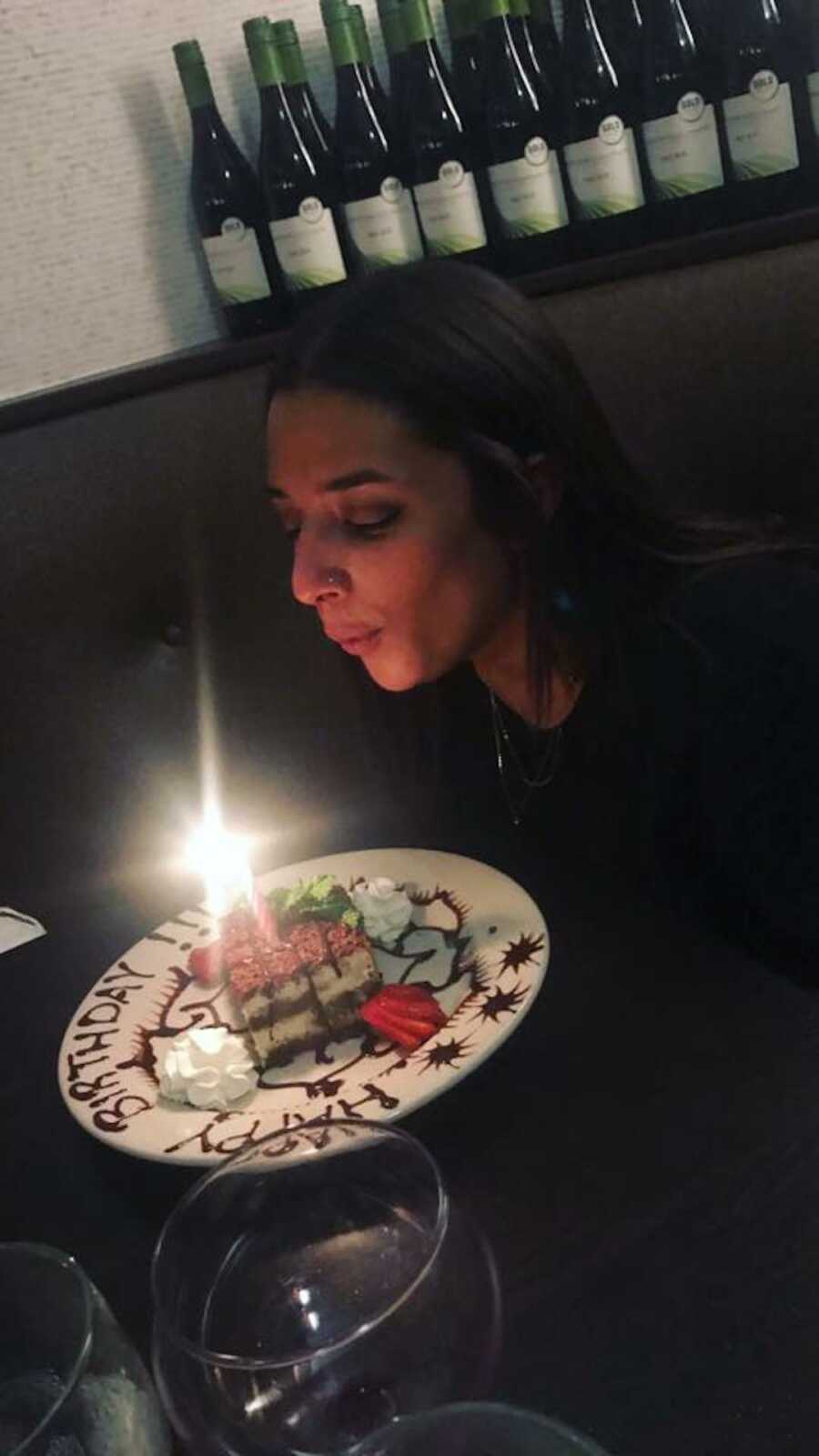 woman blowing out birthday candle 