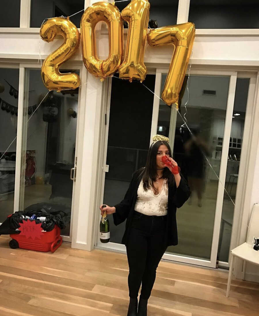 woman on new years eve drinking out of red solo cup 