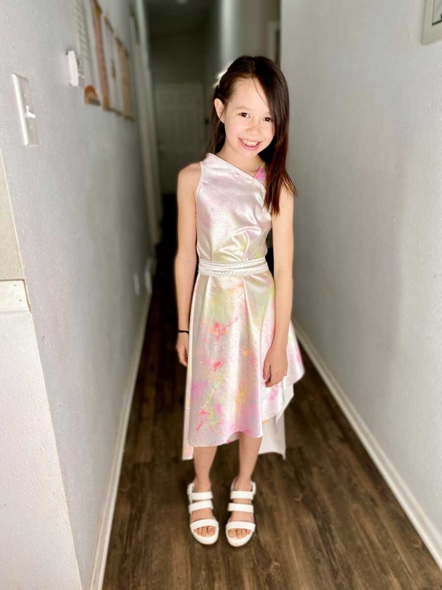 little girl wearing the dress she desgines