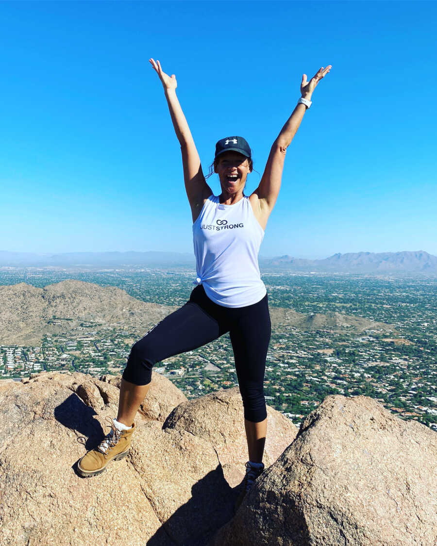 sober woman on the top of a mountain