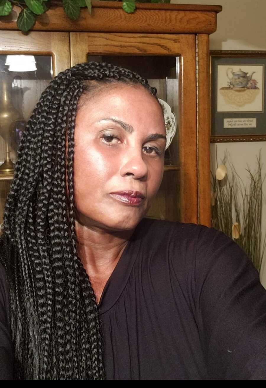 selfie of woman in black shirt with braids