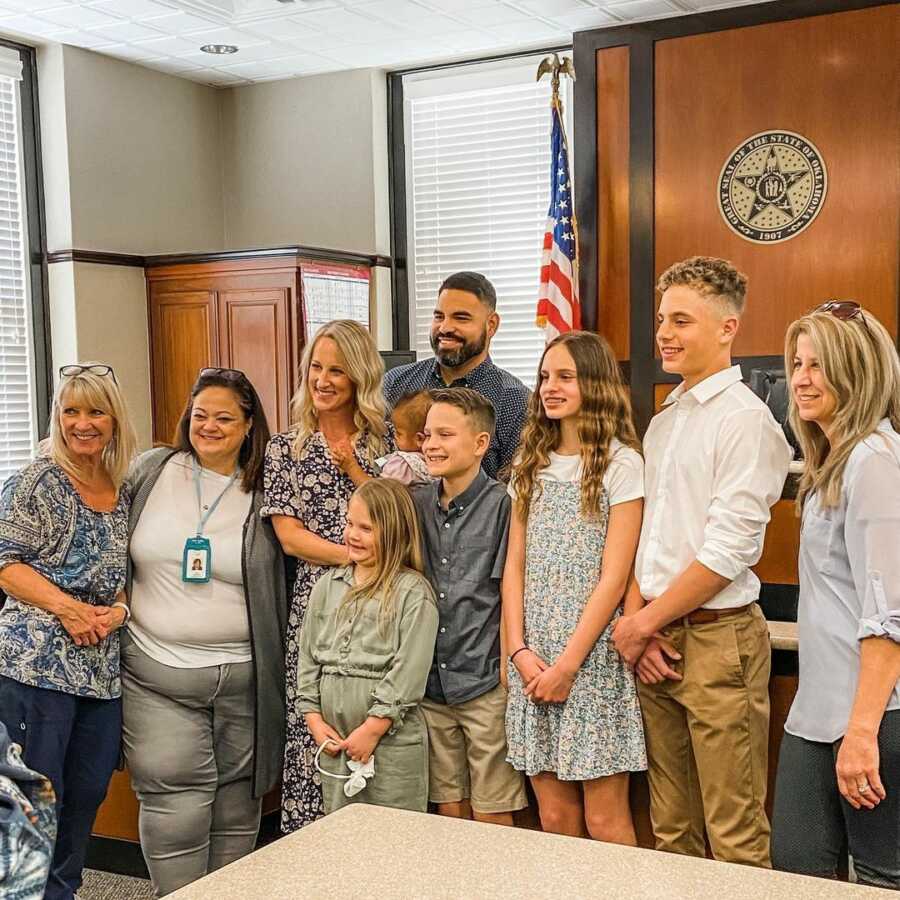 family standing in courthouse on their daughter's adoption day