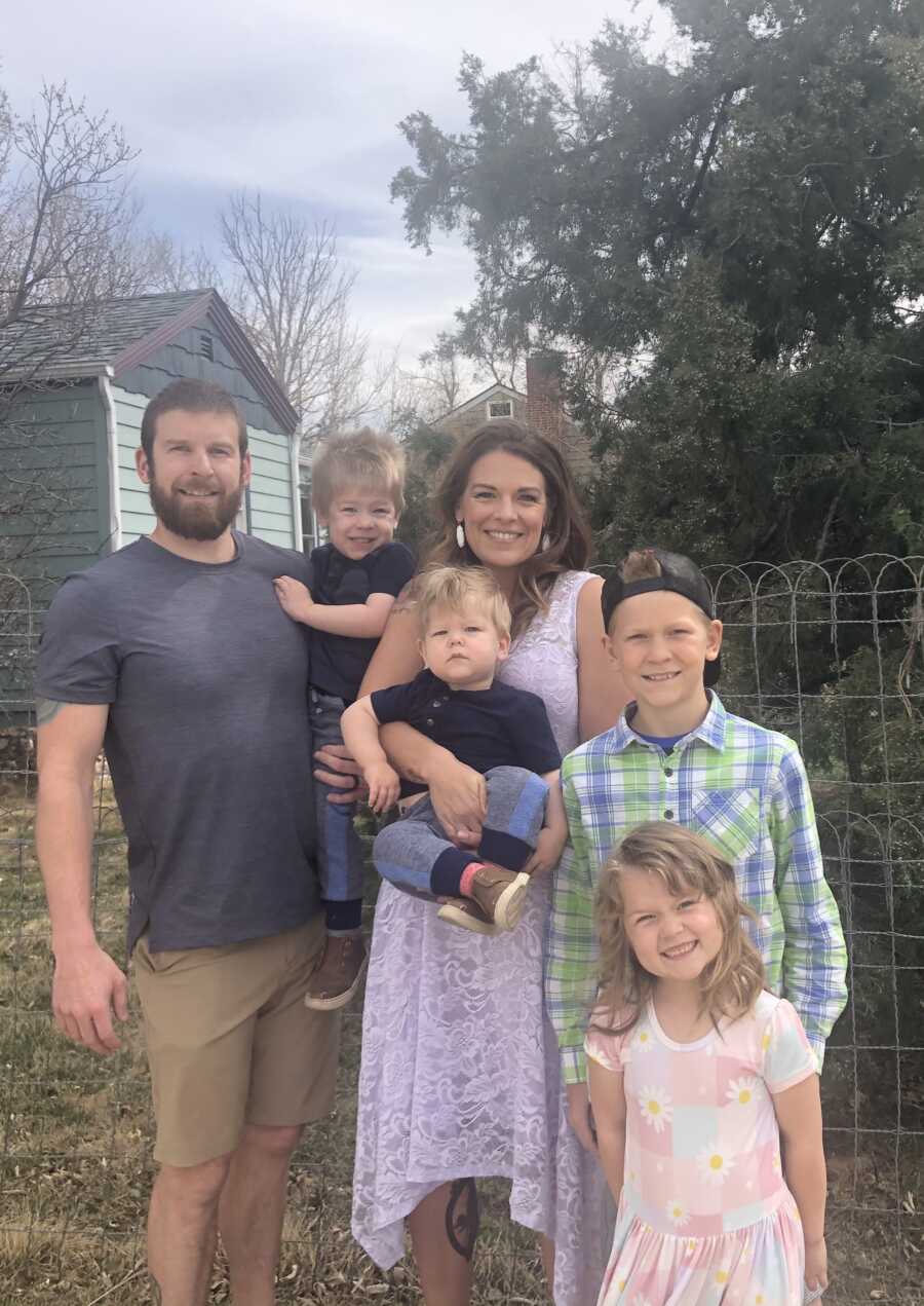 Couple takes family picture with their three boys and one girl.