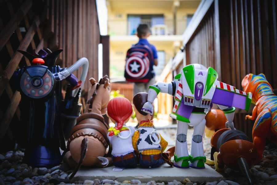 toys lined up and a child standing in the distance