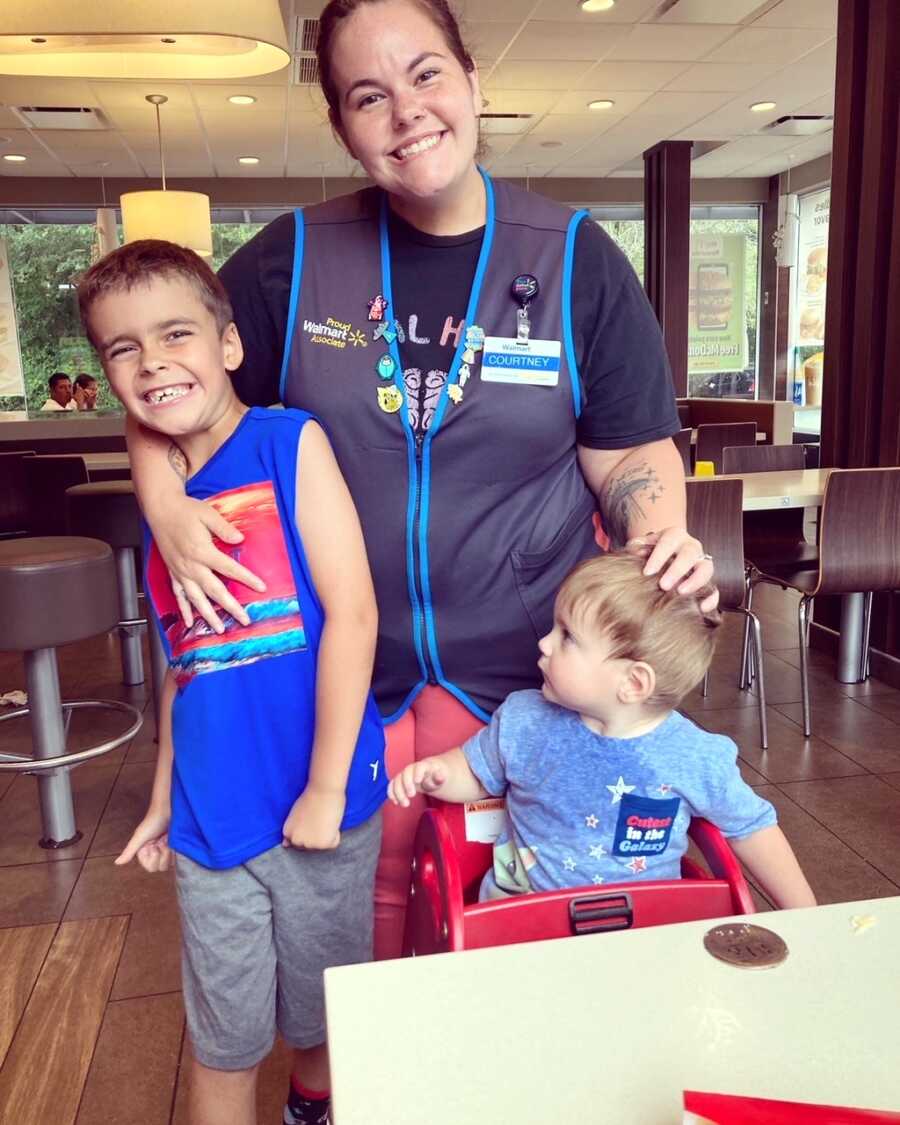 mom stands with her two sons during visitation hours