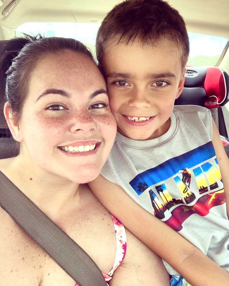 mom and son smile wide while in the car