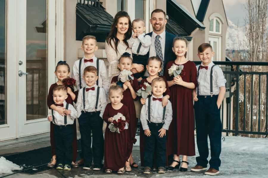 Remarried parents take wedding picture with their combined 11 children.