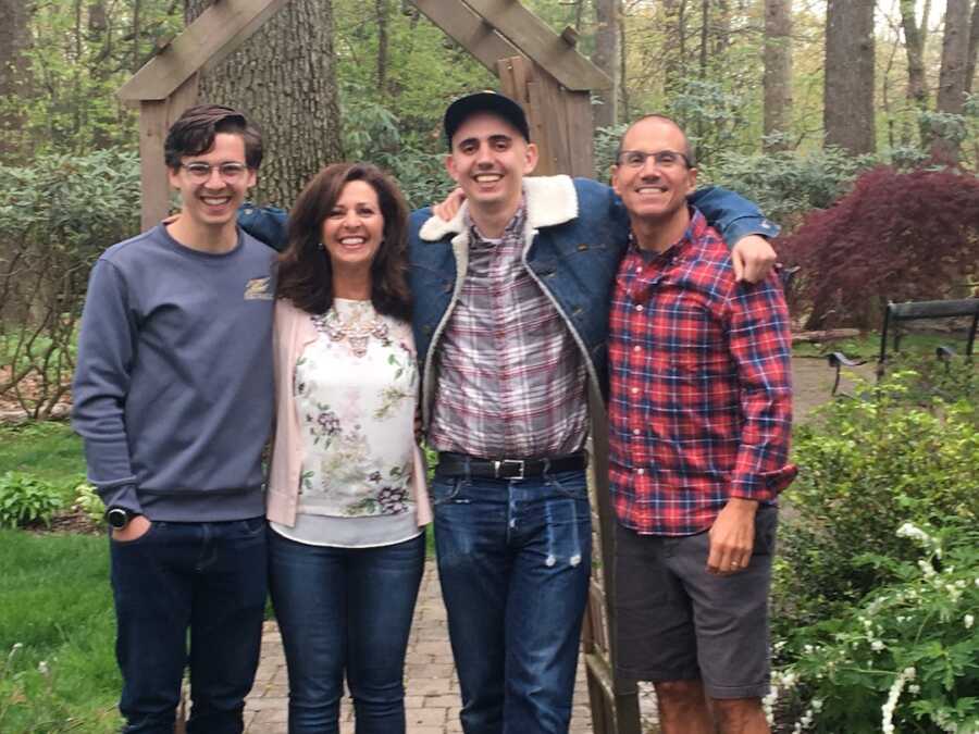 two brothers mother and father taking family photo