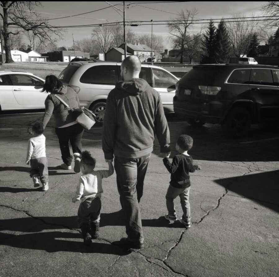 family walking with children black and white photo 
