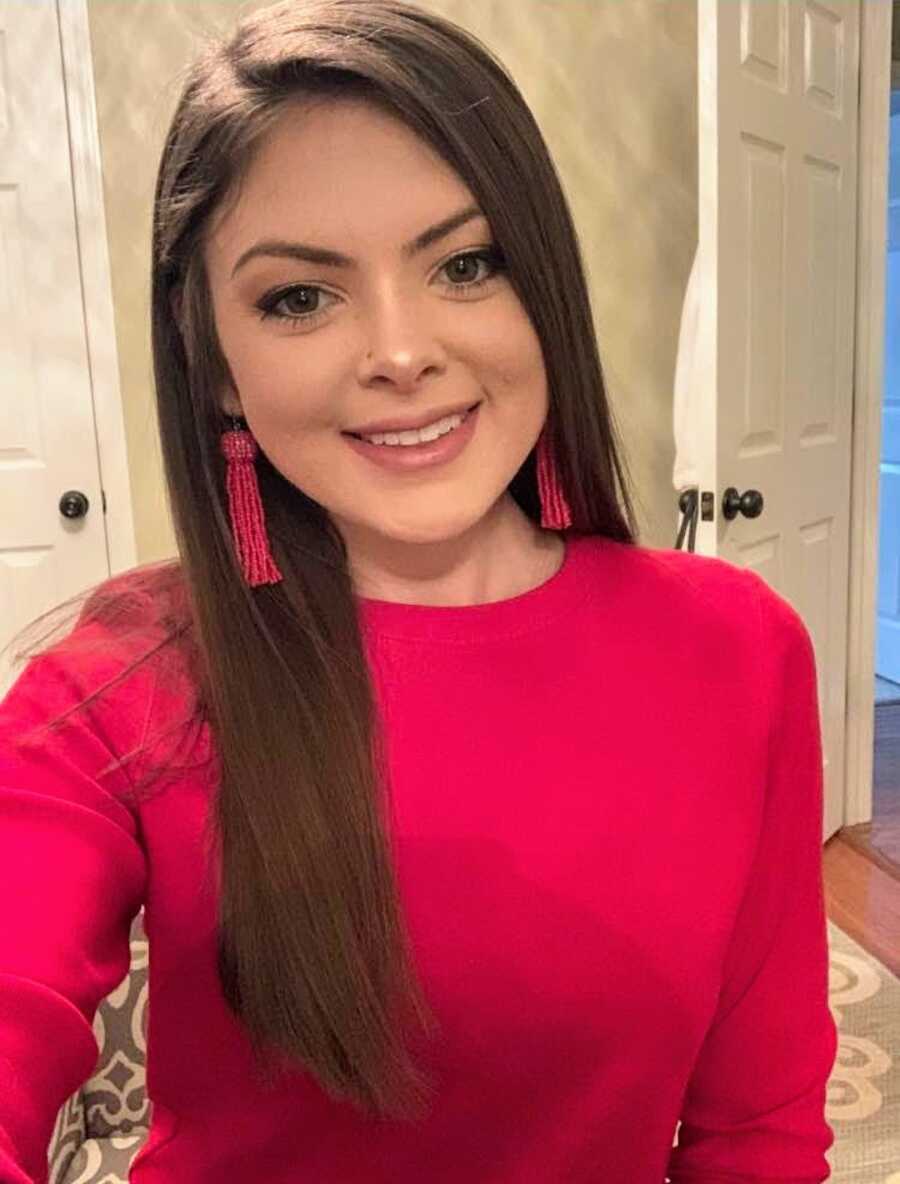 woman takes a selfie smiling