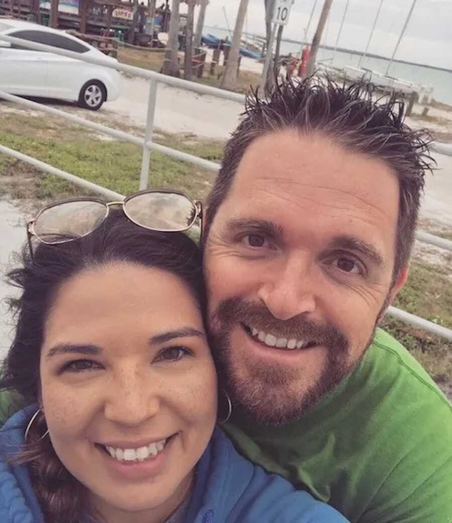 husband and wife take selfie while smiling wide