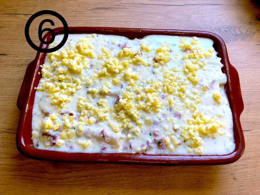 canelones in pan before baking, covered in parmesan cheese