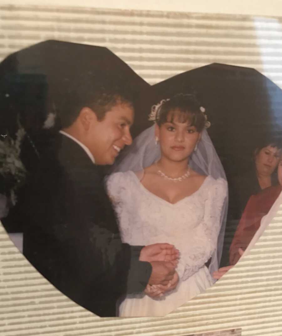 A woman and man cut the cake on their wedding day