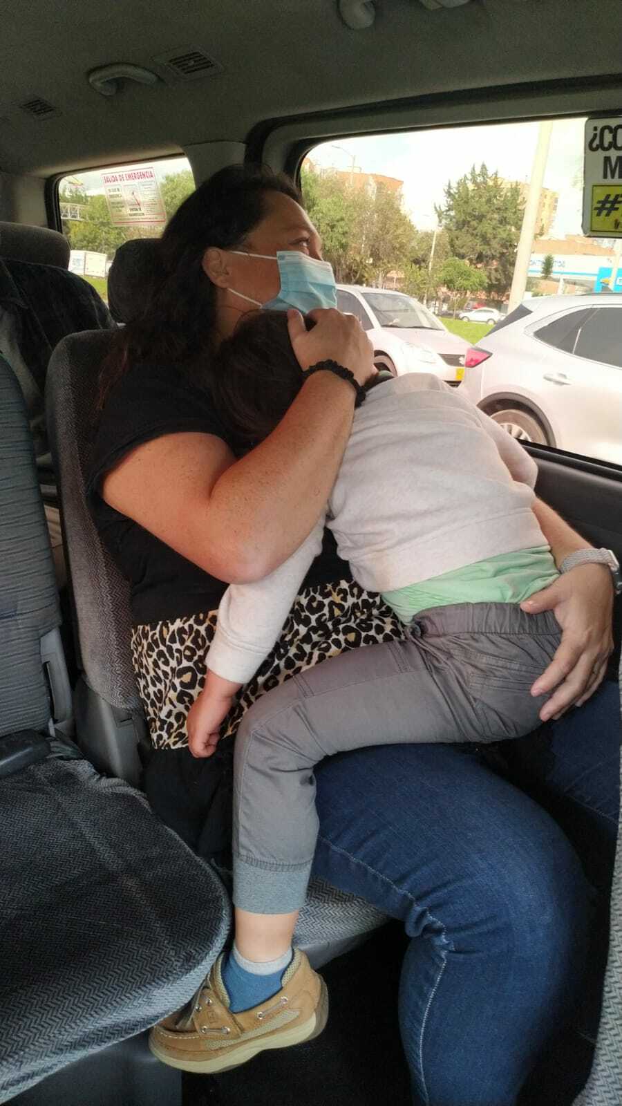 Newly adopted toddler falls asleep on mom's lap as they travel home to the United States.