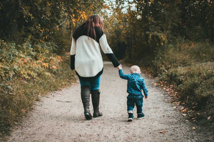 woman walking with little boy 