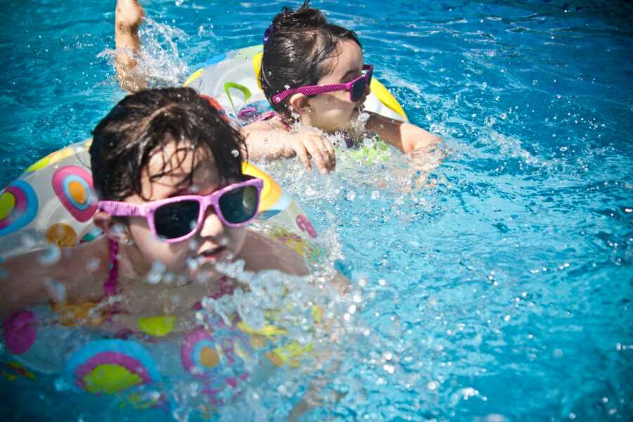 two kids swimming and enjoying life