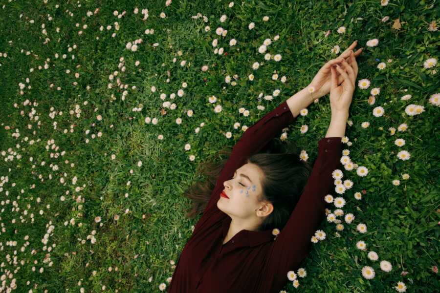 woman laying in the grass relaxing