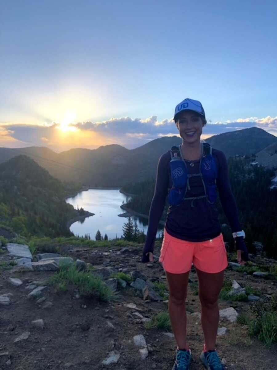 woman standing in front of mountains on hill