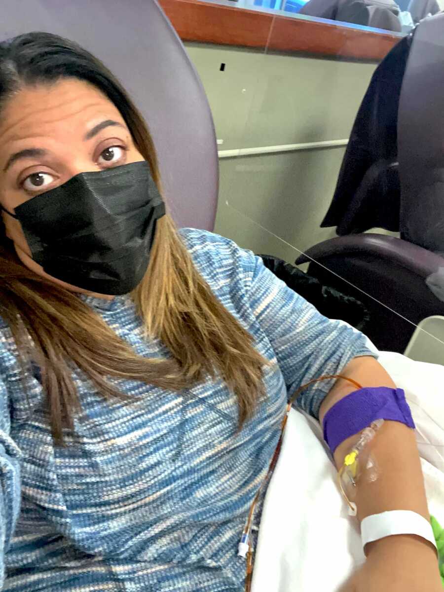 woman sits in chair getting an iron infusion for her anemia