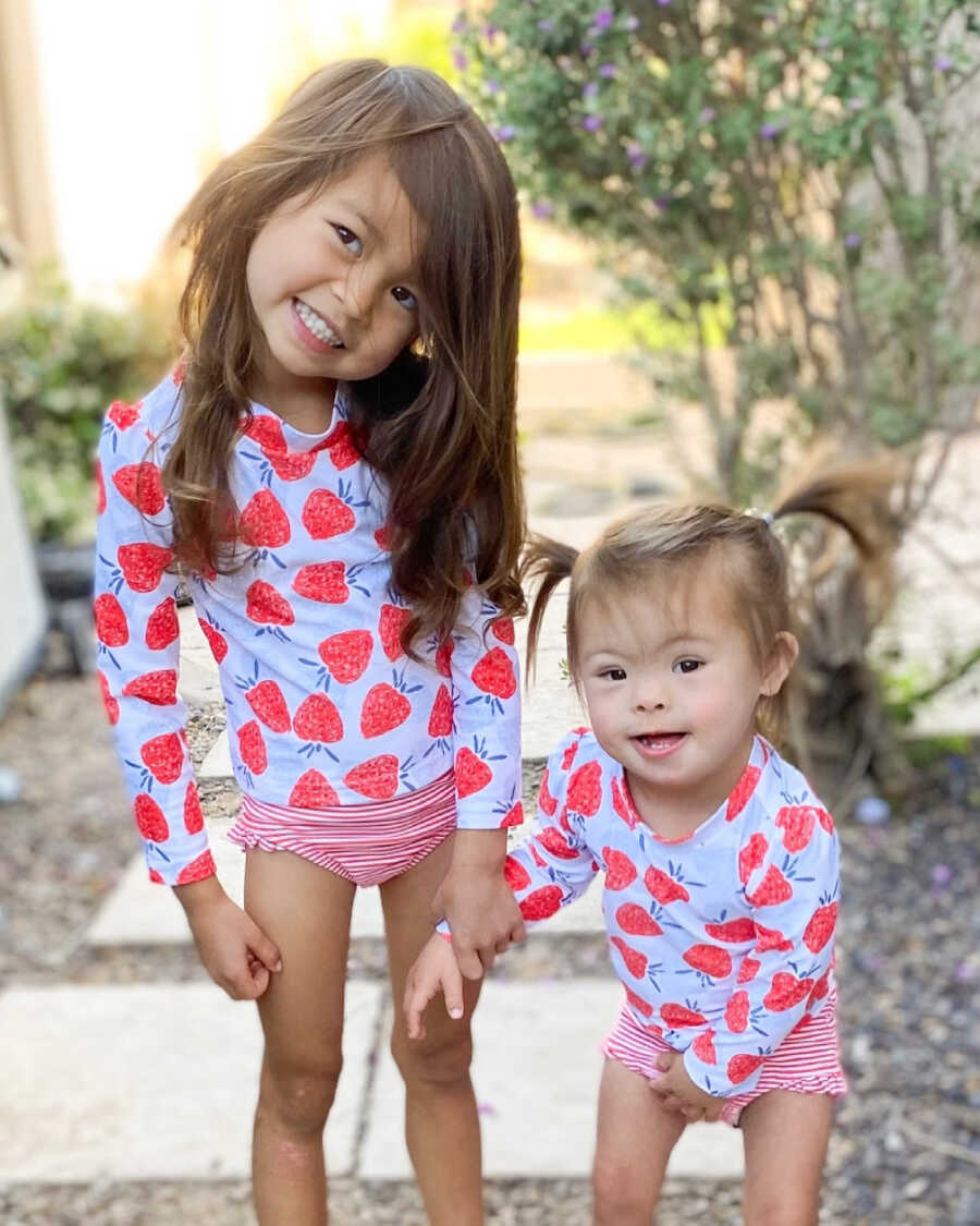 sisters in matching bathing suits