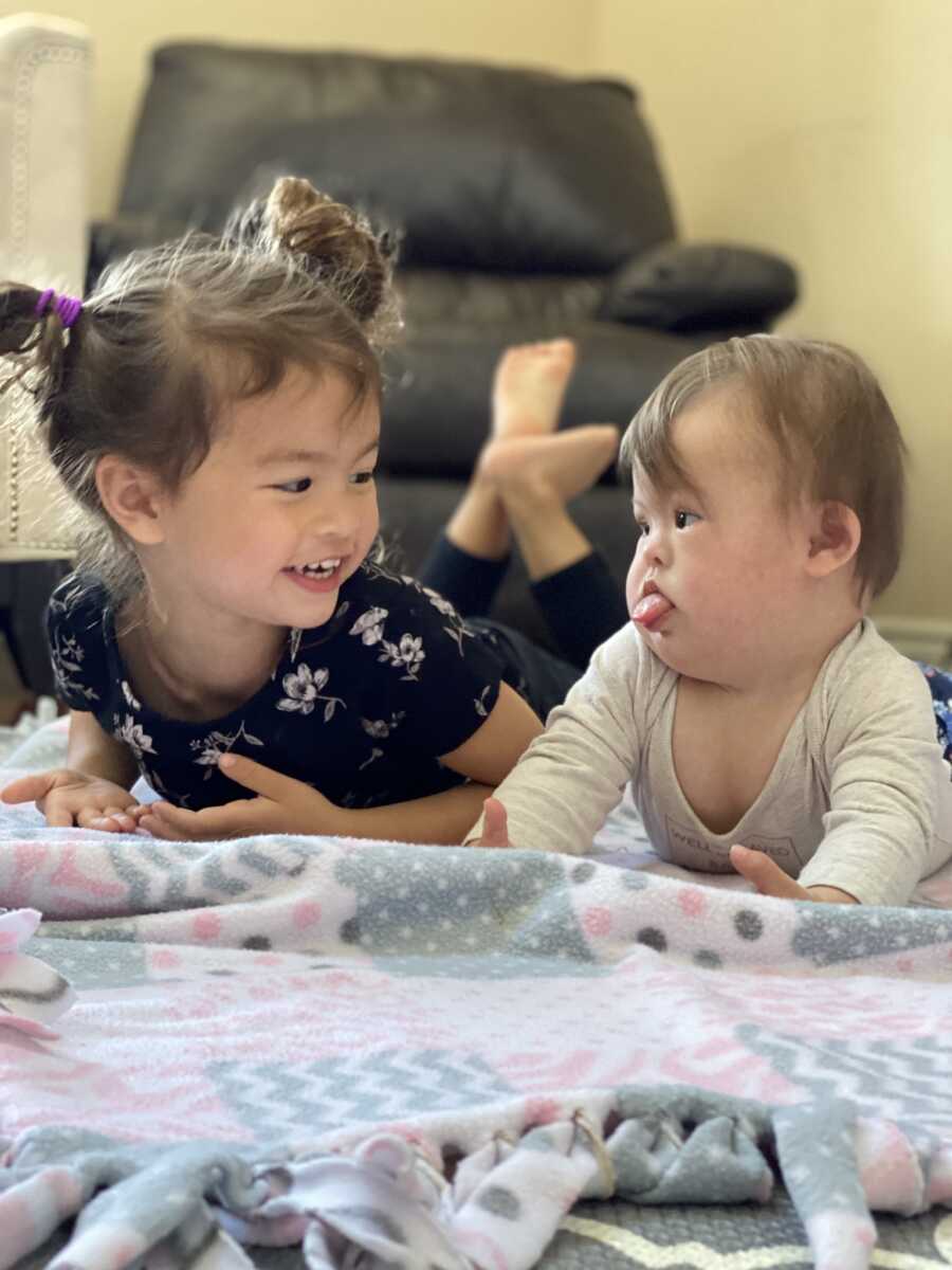 sisters on the floor for tummy time together