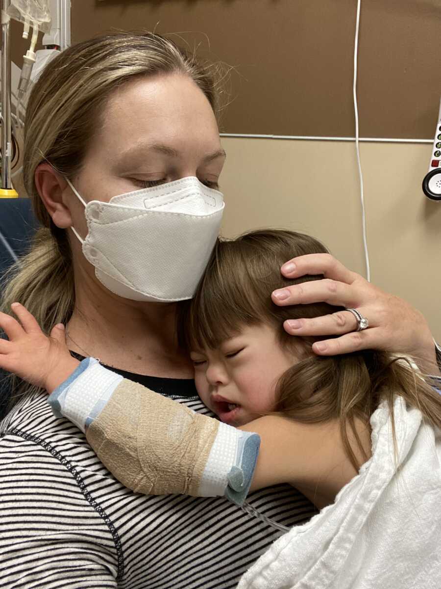 mom cradling her daughter close in the hospital