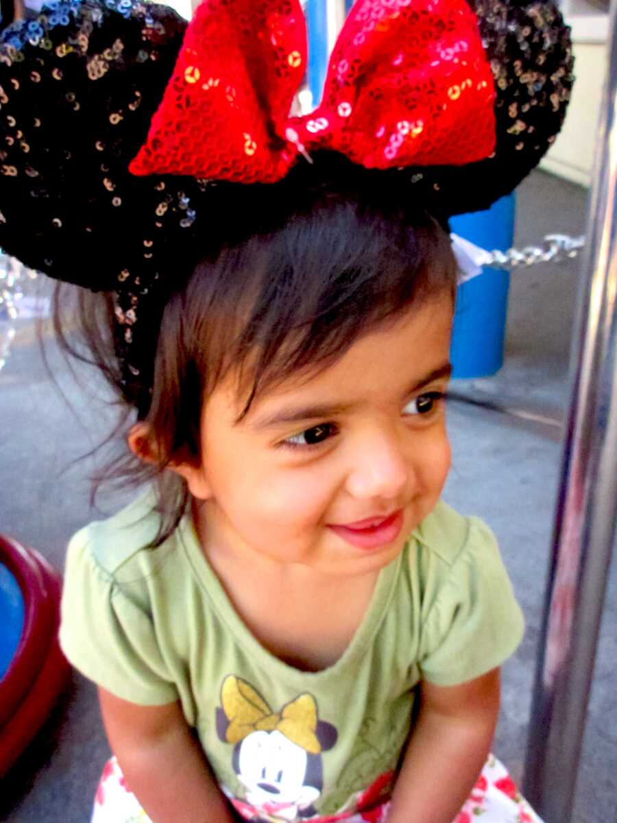 young girl wearing mickey ears