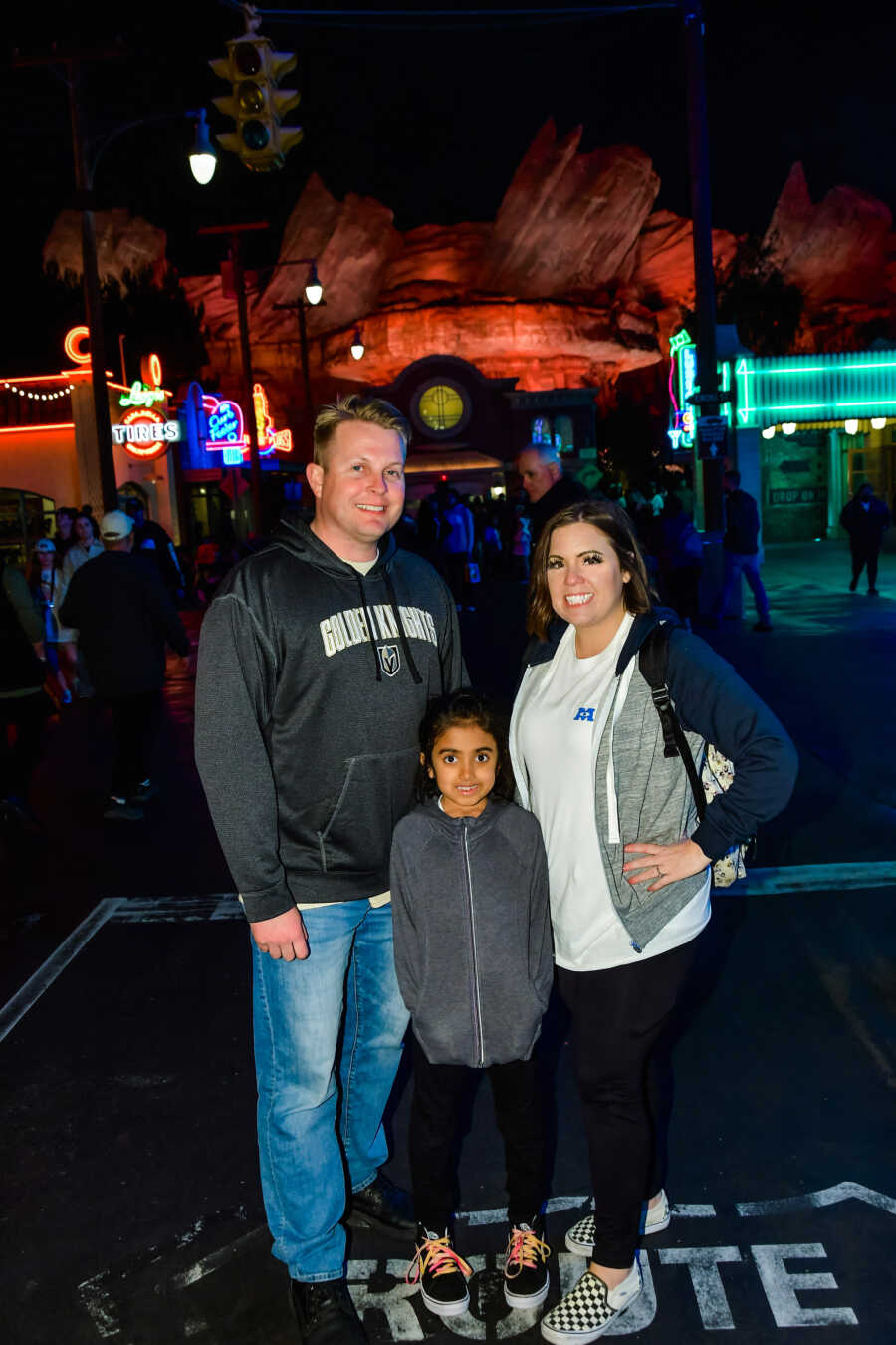 parents stand with their daughter