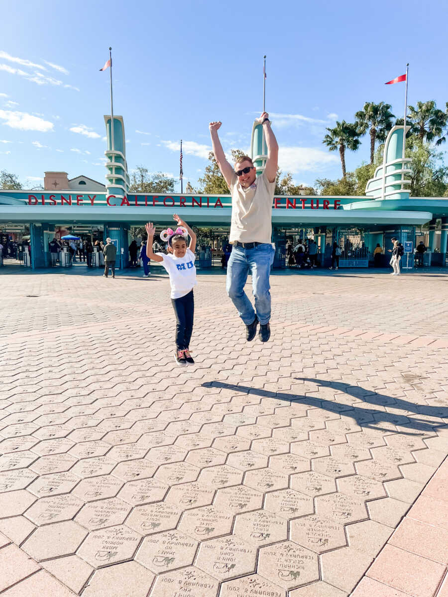 dad with daughter outside of Disneyland