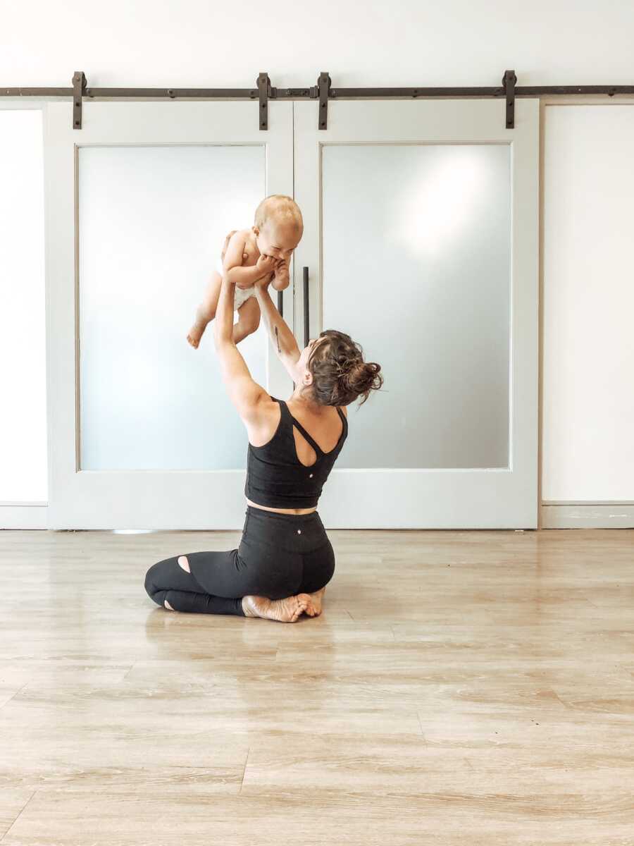 mom lifting up her baby