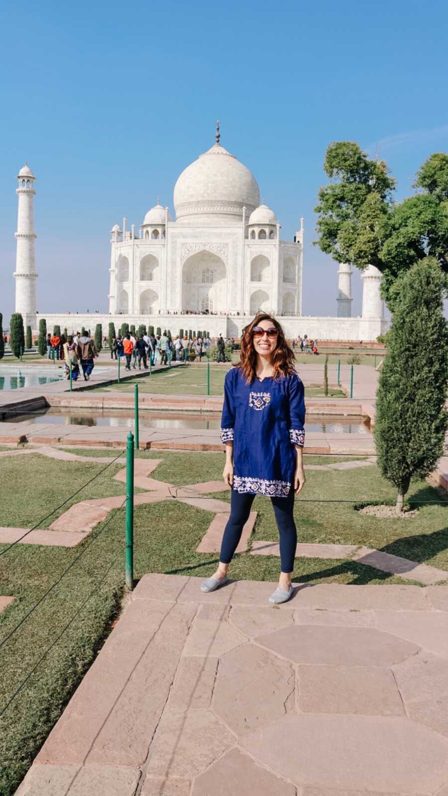 woman standing in front of a seven wonder