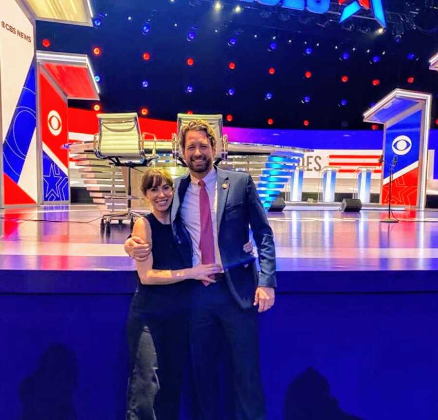 couple in front of political stage