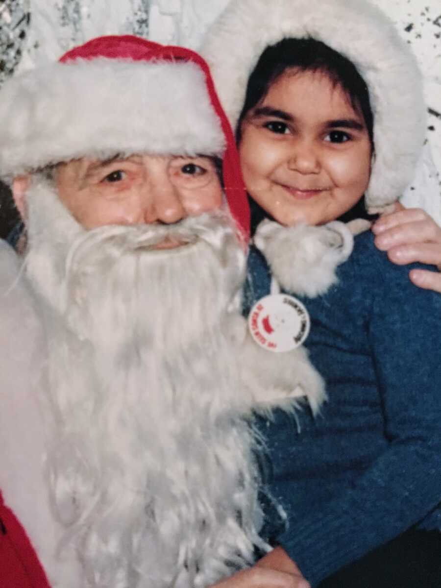 abuse survivor sitting with Santa and smiling