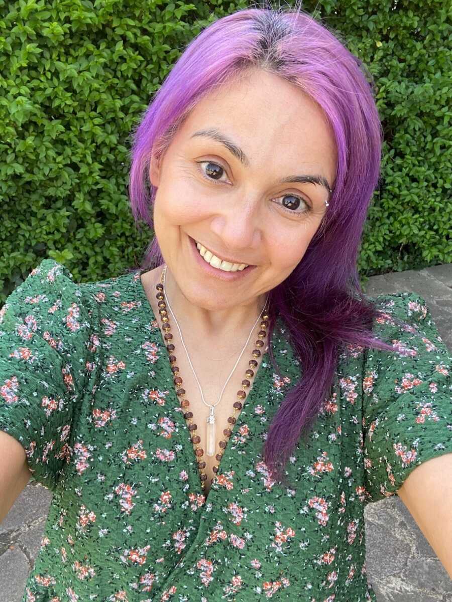 domestic violence survivor with purple hair smiling