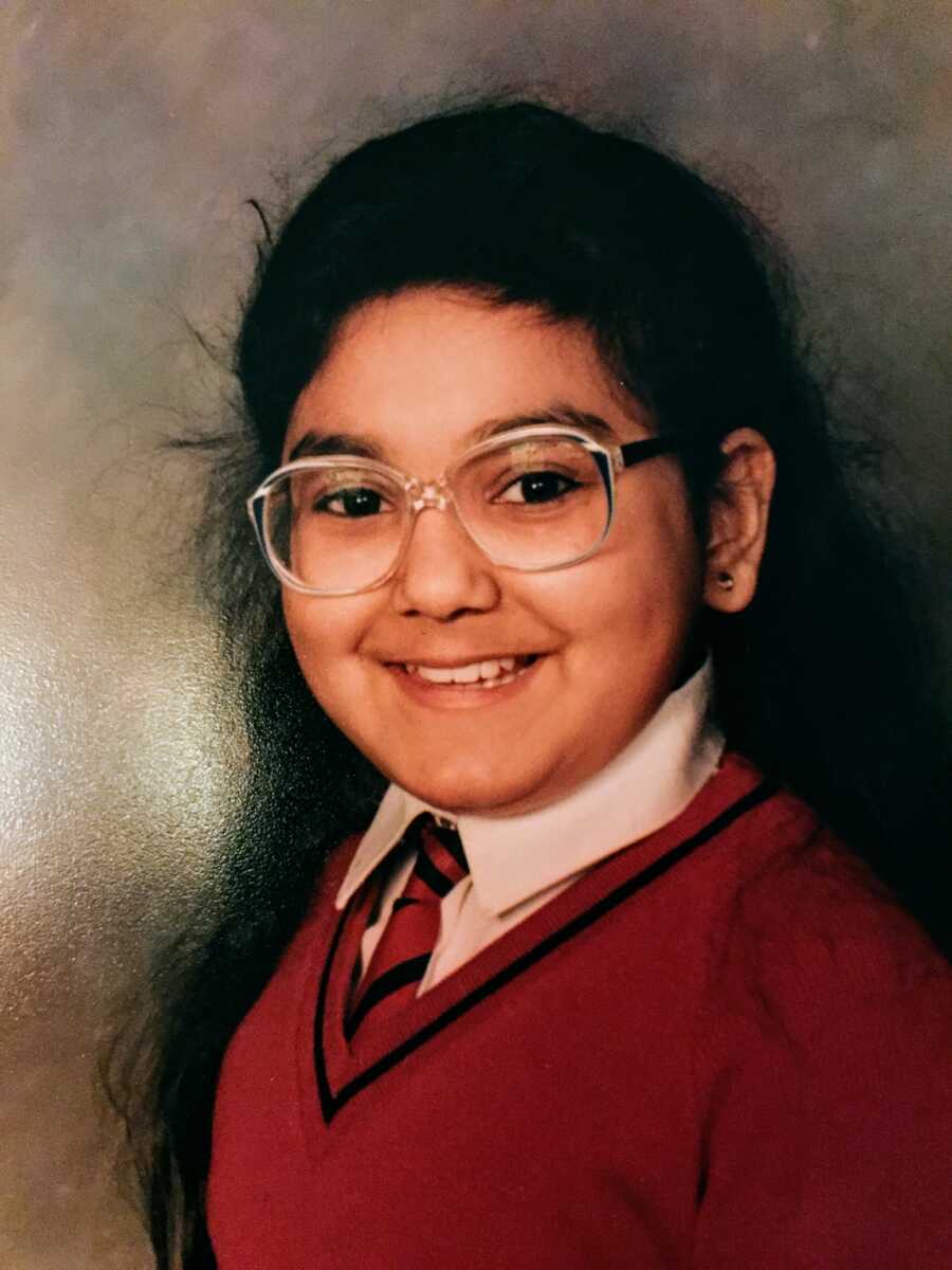 abuse survivor smiling in school photo