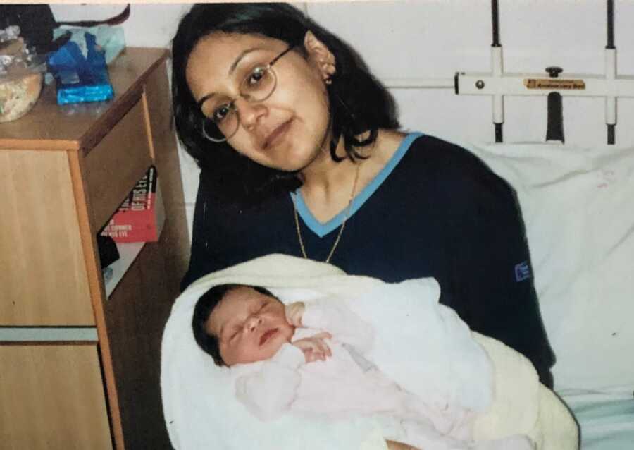 domestic violence survivor in hospital holding newborn baby girl