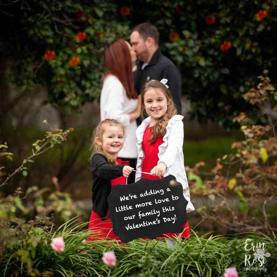 parents announcing their third pregnancy with their daughters