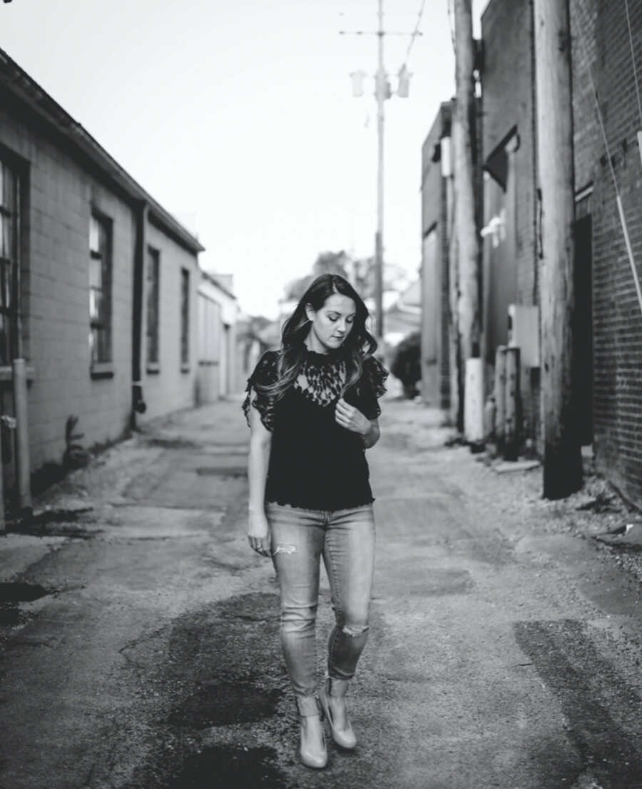 Woman in black and white picture in alley